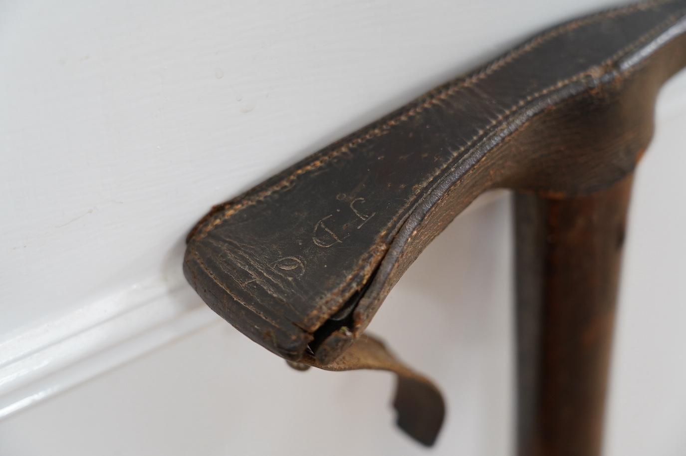 An Edward Hill & Son early 20th century Alpine mountaineer’s axe with original stamped leather cover, 99cm long. Condition - fair to good